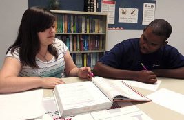 A photo of a student tutoring another student