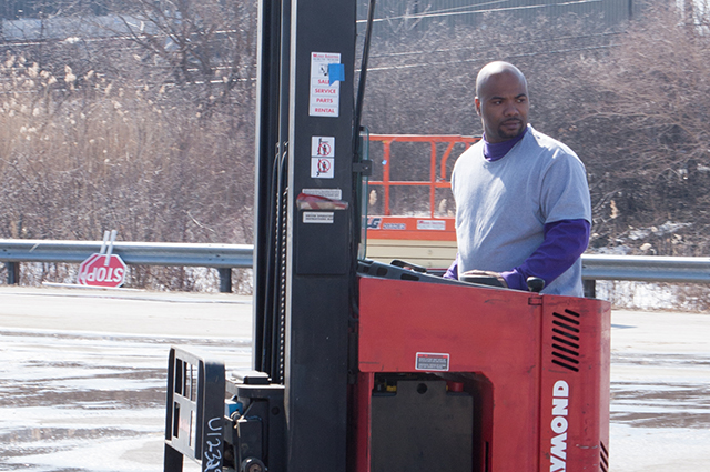 Photo of a man operating a forklift