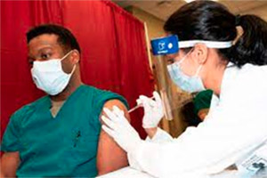 Photo of an African American man getting vaccinated